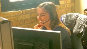 a thresholds staff person on the phone using a headset